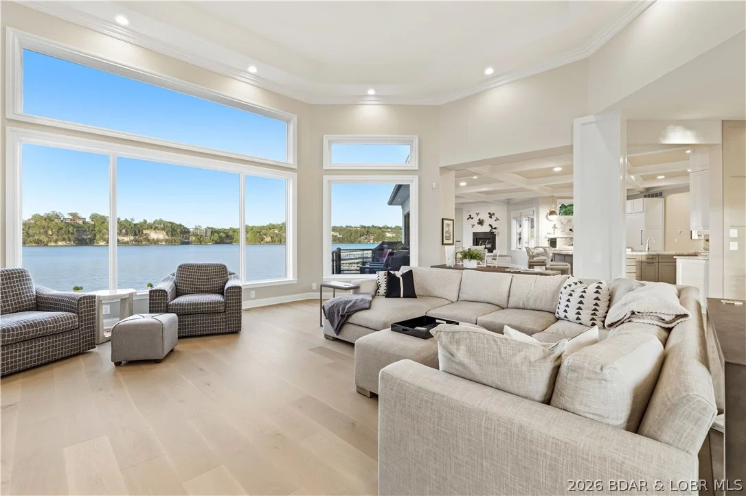 Great room with a wall of windows overlooking the lake